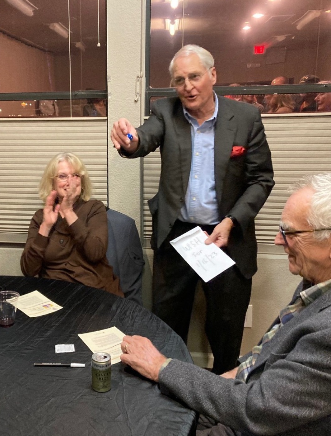 Jim Bodine performing close-up magic for a table of guests